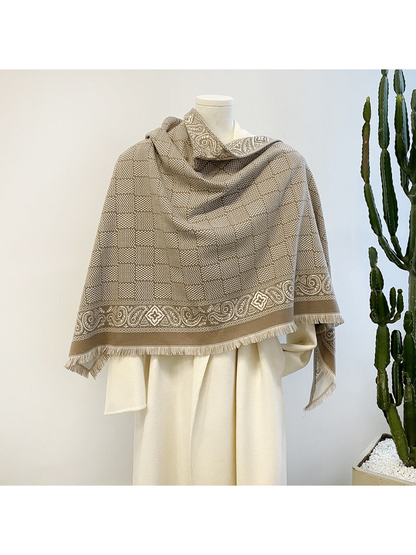 Khaki geometric scarf with paisley border and short fringe draped on a mannequin