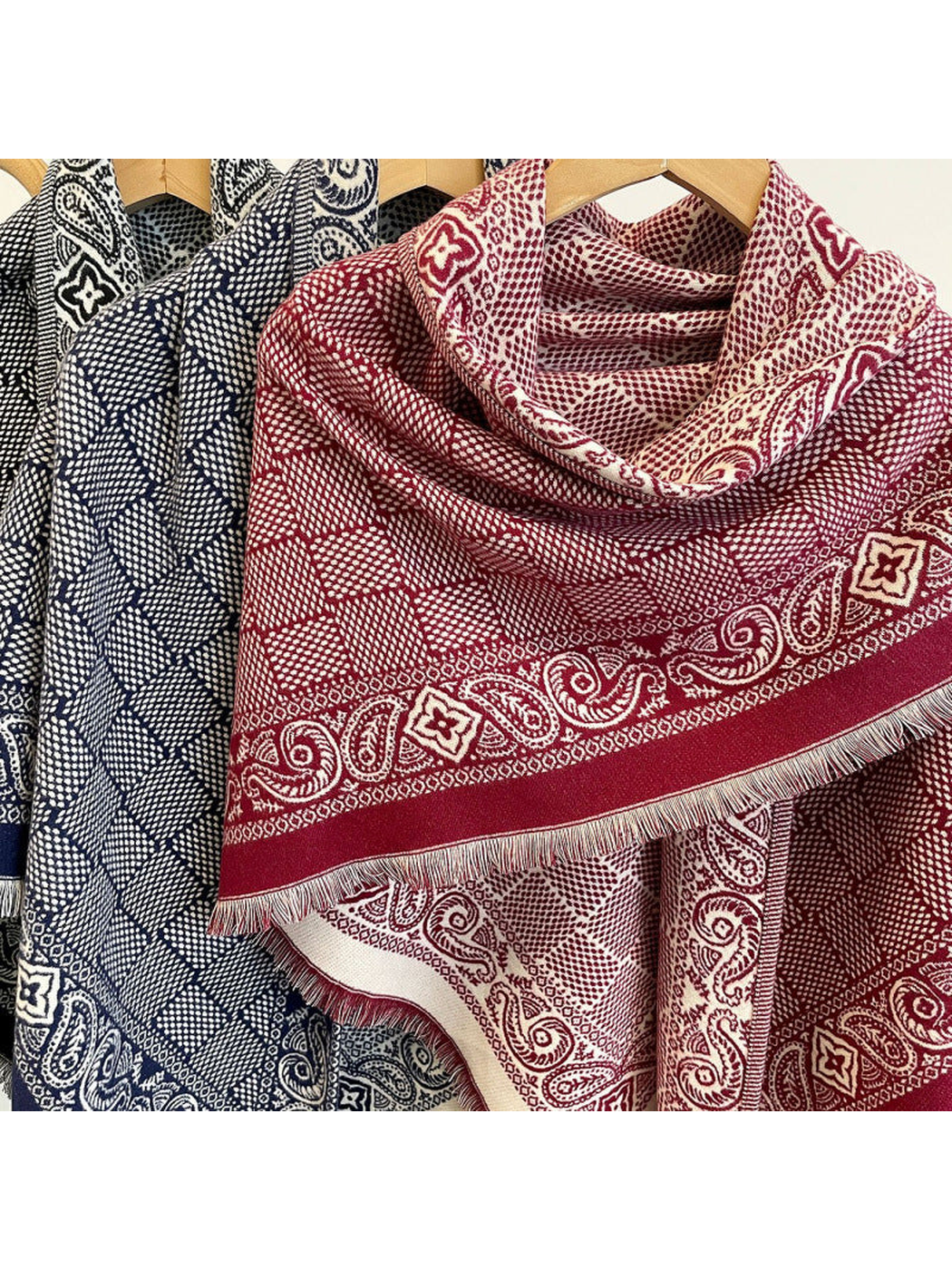 Close-up of Burgundy and Navy scarves with geometric fields, paisley borders and short fringe
