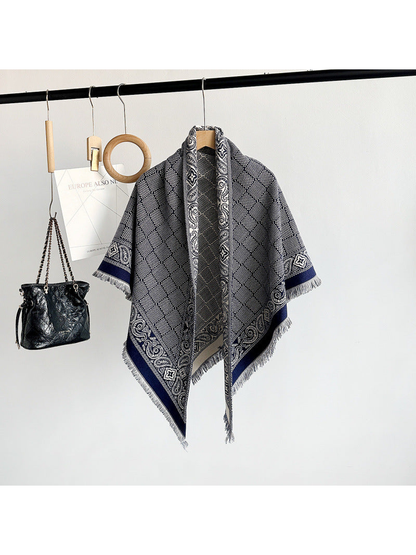 Navy geometric scarf with paisley border and short fringe displayed on a hanger