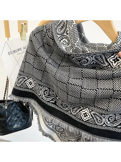 Close-up of the Black scarf's geometric field, paisley border, short fringe and lighter reverse