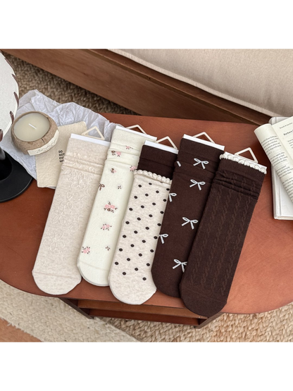 Five crew sock styles with bow, floral, polka-dot and cable designs