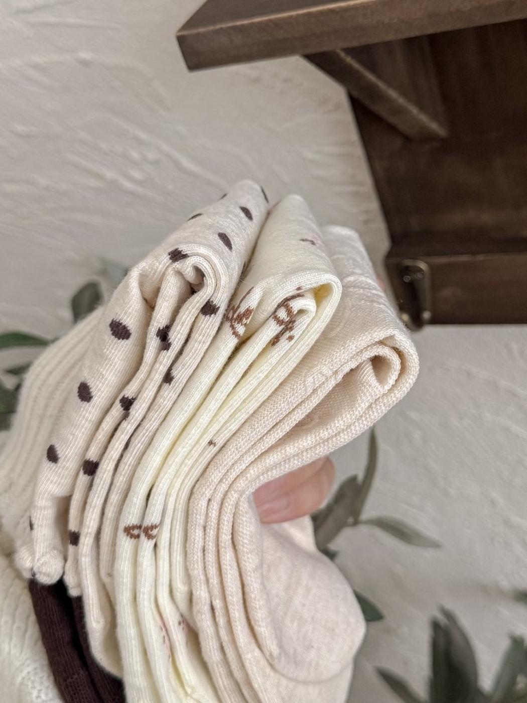 Close-up of folded ivory patterned socks and their finished edges