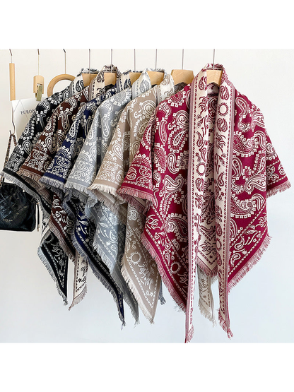 Paisley triangle scarves in multiple colors displayed on hangers
