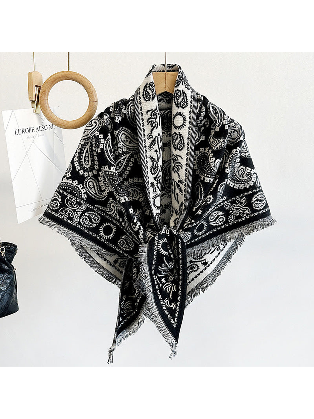 Black paisley triangle scarf with short fringe, hanging view