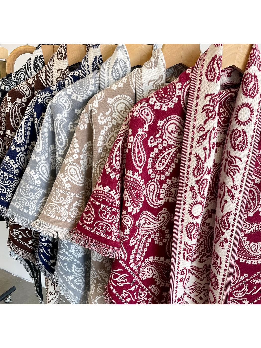 Close-up of paisley patterns and fringed borders in multiple colors