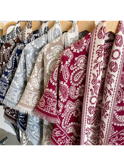 Close-up of paisley patterns and fringed borders in multiple colors