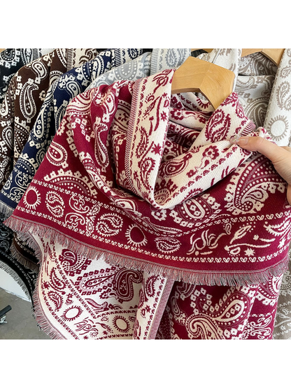 Close-up of the burgundy paisley pattern and short fringed edge