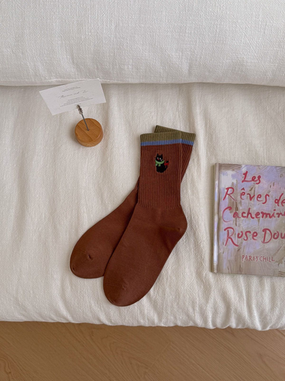 Flower Cat caramel brown crew socks with blue striped cuffs