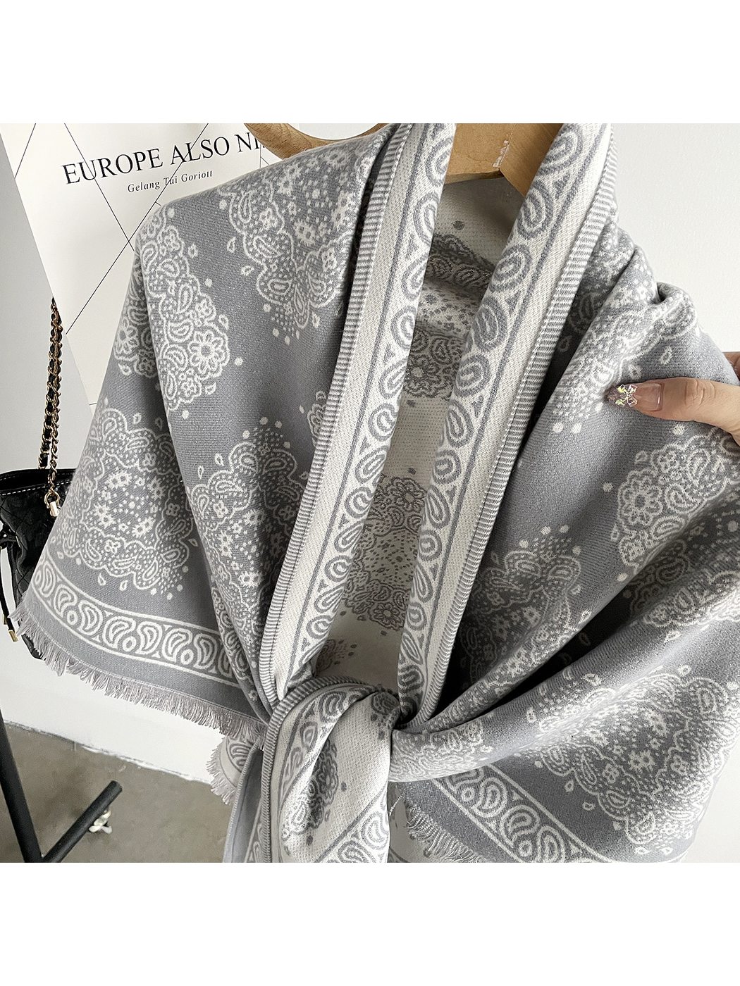 Close-up of the Light Gray scarf's woven-look surface, medallion motifs, and patterned border