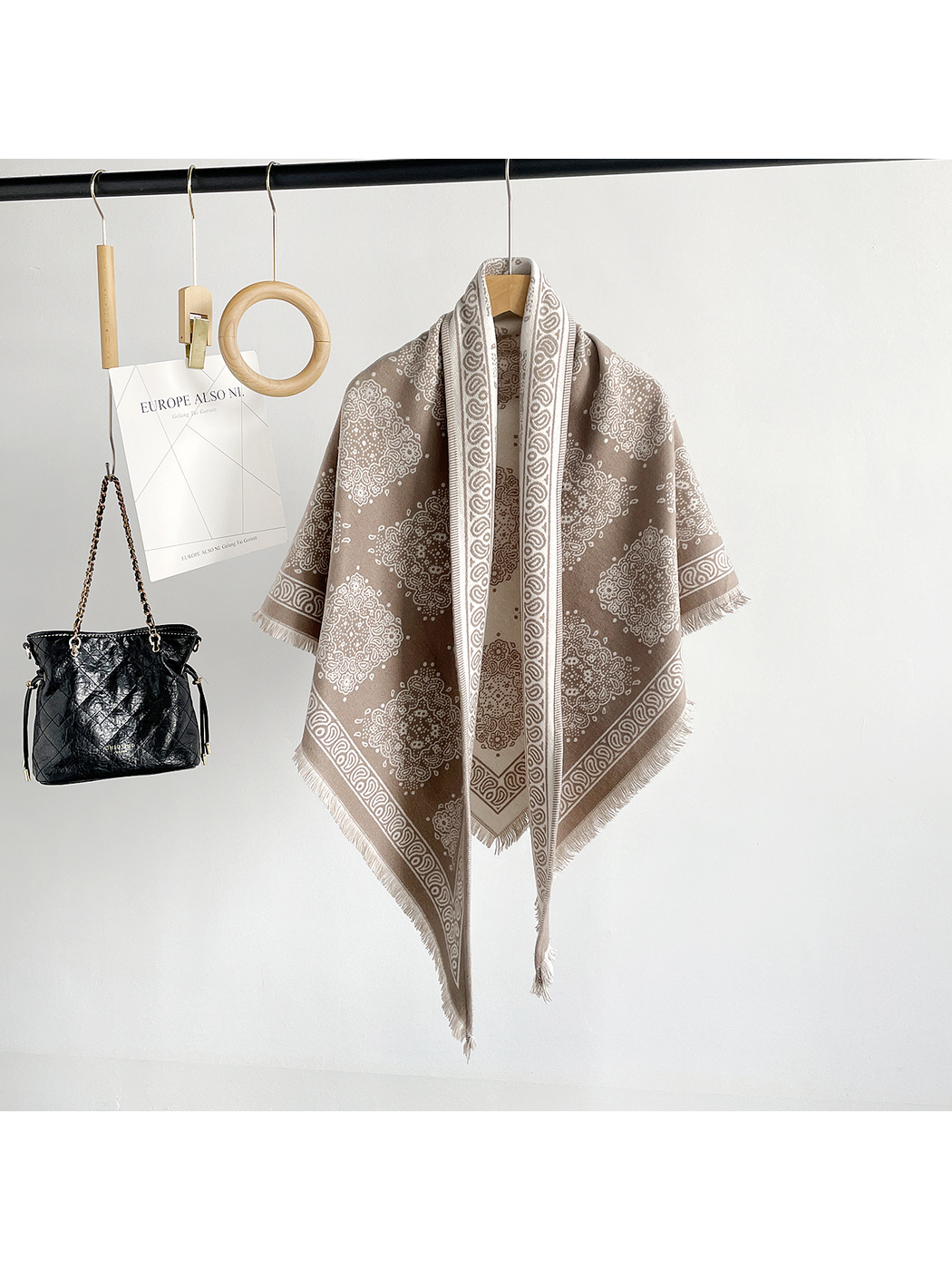 Khaki medallion-pattern triangle scarf hanging in a full-length front view