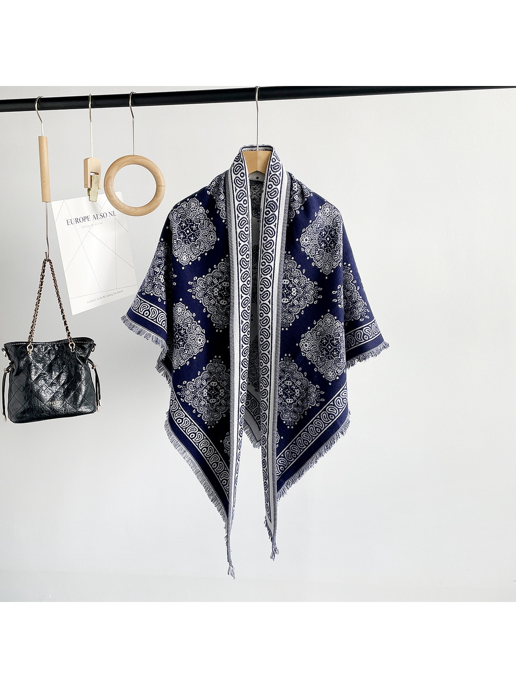 Navy medallion-pattern triangle scarf hanging in a full-length front view