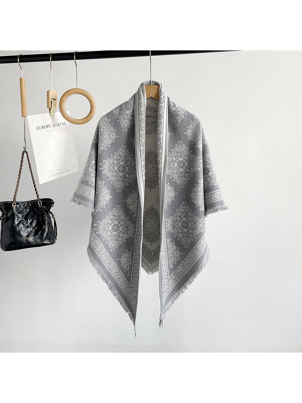 Light Gray medallion-pattern triangle scarf hanging in a full-length front view