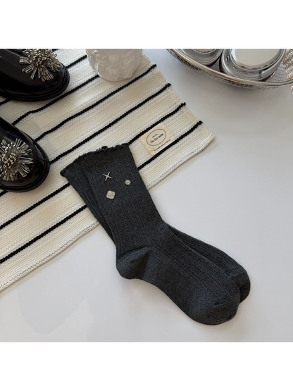 Dark Gray crew socks with ribbed texture, ruffled cuffs and silver-tone accents