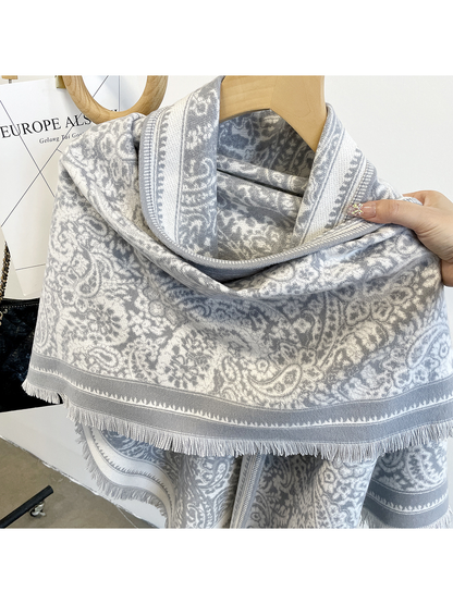 Close-up of the light gray paisley pattern, contrasting border and short fringe