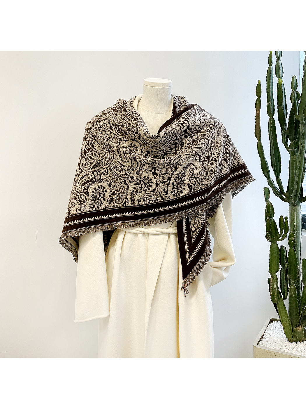 Brown paisley triangle scarf draped over a mannequin