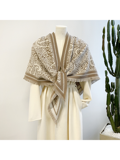 Khaki paisley triangle scarf tied at the front on a mannequin