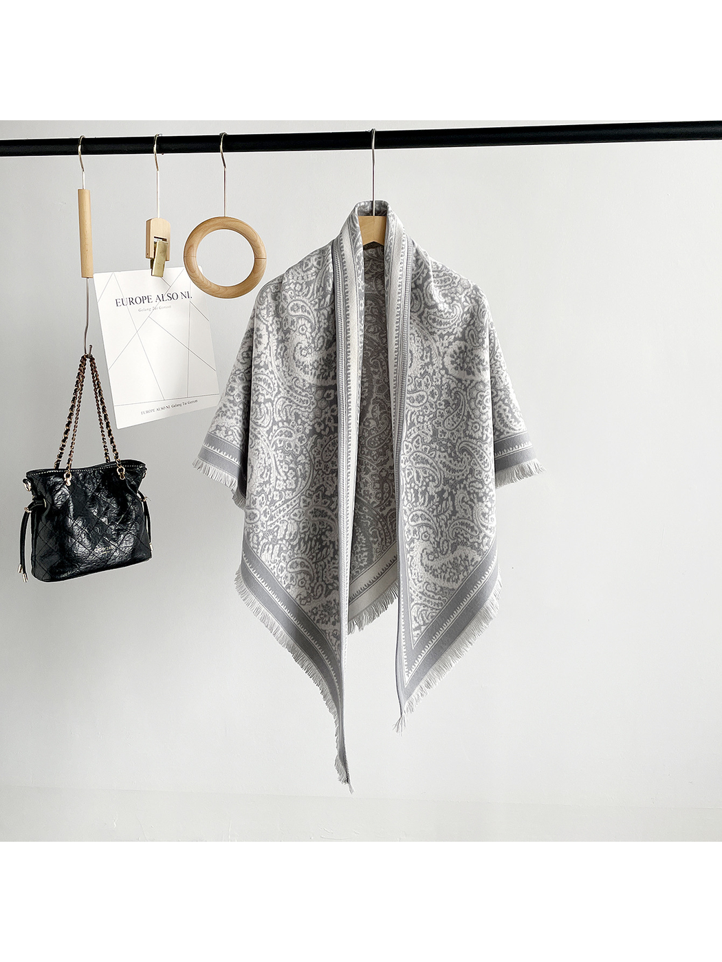 Light Gray paisley triangle scarf with contrasting border and short fringe, full hanging view