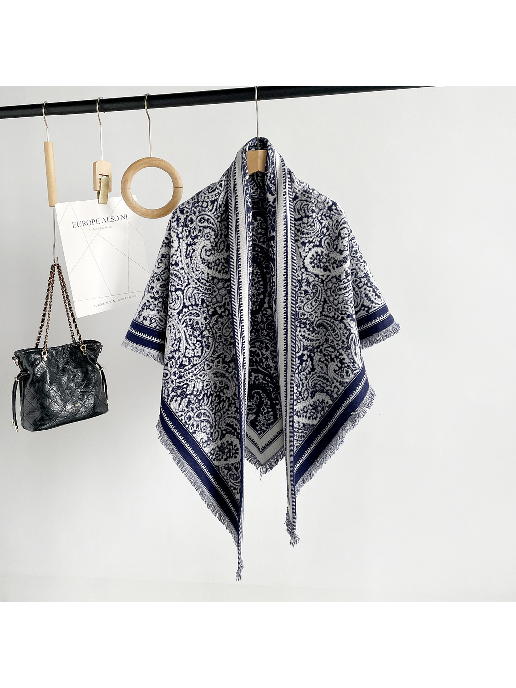 Navy paisley triangle scarf with contrasting border and short fringe, full hanging view