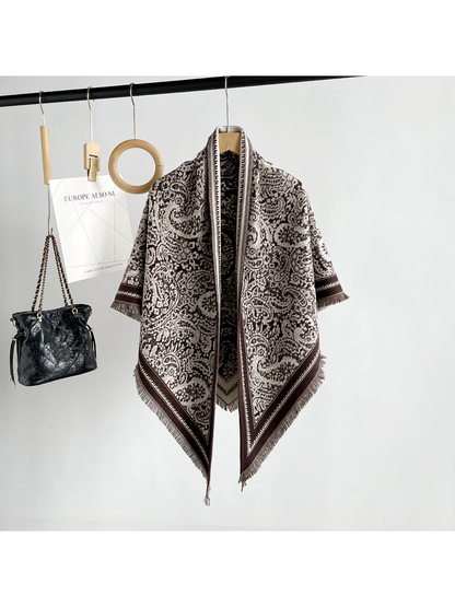 Brown paisley triangle scarf with contrasting border and short fringe, full hanging view