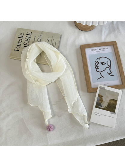 Ivory sheer scarf with wavy edges and pom-pom and bead end accents