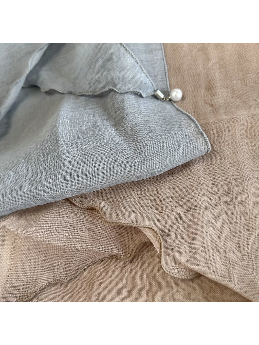 Close-up of Blue Gray and Greige scarf edges with a round bead accent