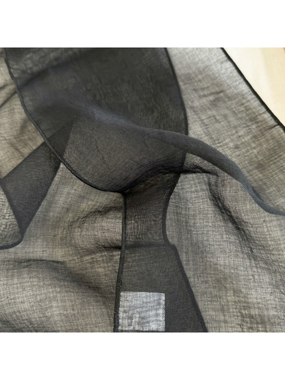 Close-up of the Black scarf's sheer woven-look surface