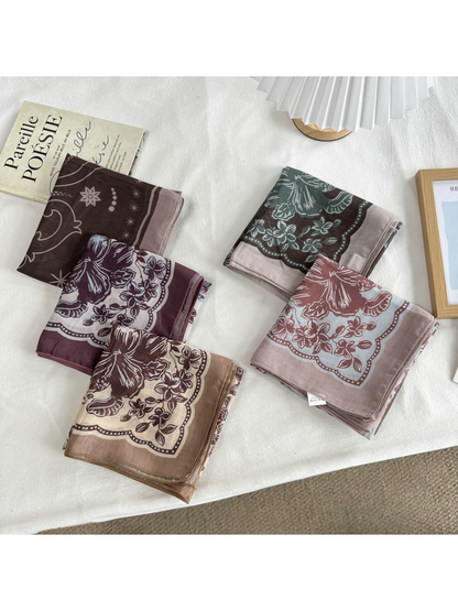 Five patterned square scarves folded together