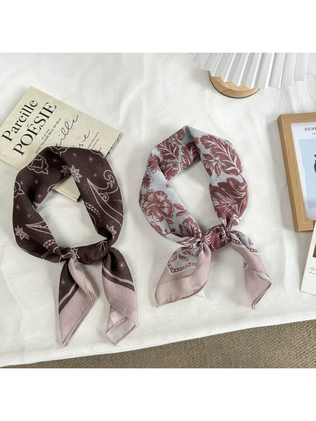 Two patterned square scarves styled with knotted ends