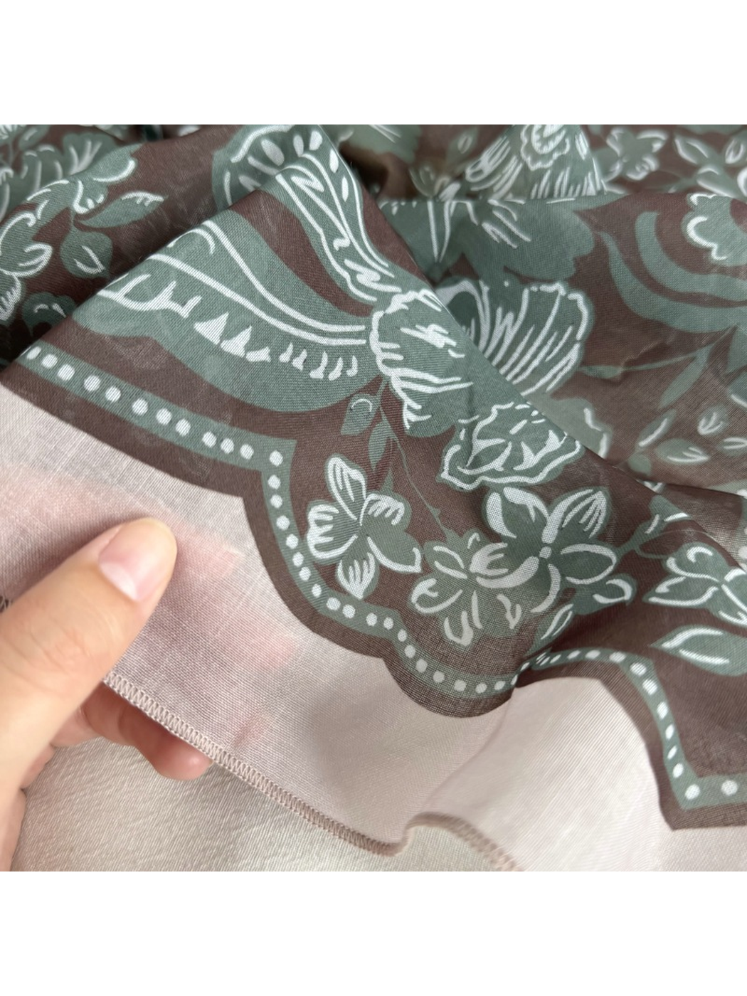 Close-up of the narrow stitched scarf edge and floral border