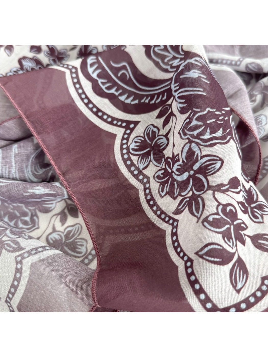 Close-up of the semi-sheer floral scarf and finished edge