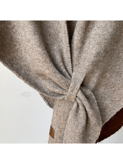 Close-up of the heathered knit texture and tied drape
