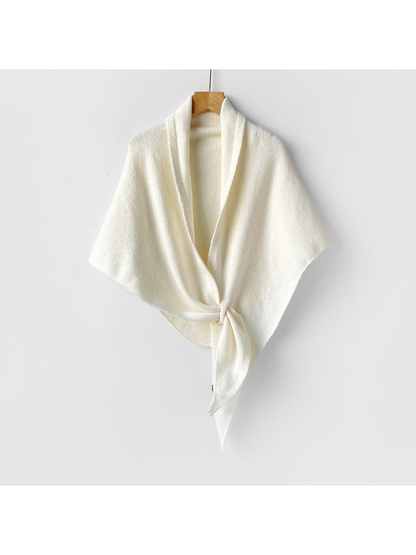 Ivory triangle shawl tied on a wooden hanger