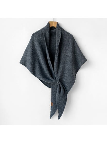 Dark gray triangle shawl tied on a wooden hanger