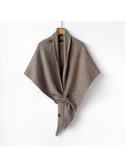 Greige triangle shawl tied on a wooden hanger