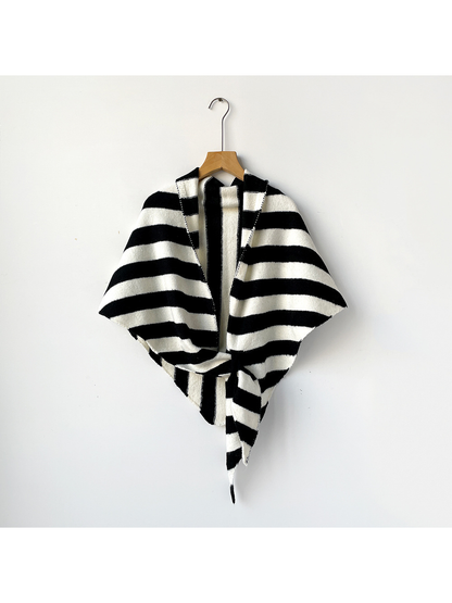 Black and ivory striped triangle shawl tied on a wooden hanger