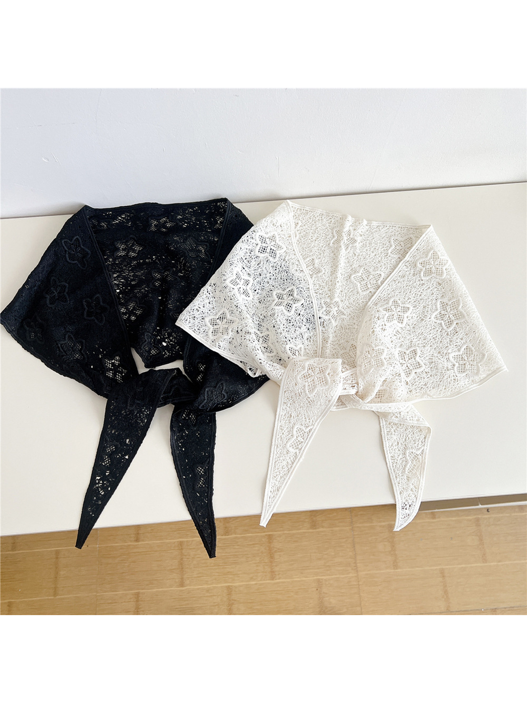 Black and Ivory floral openwork triangle scarves displayed side by side