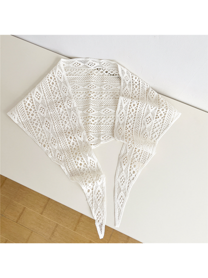 Ivory openwork triangle scarf laid open with long pointed tie ends