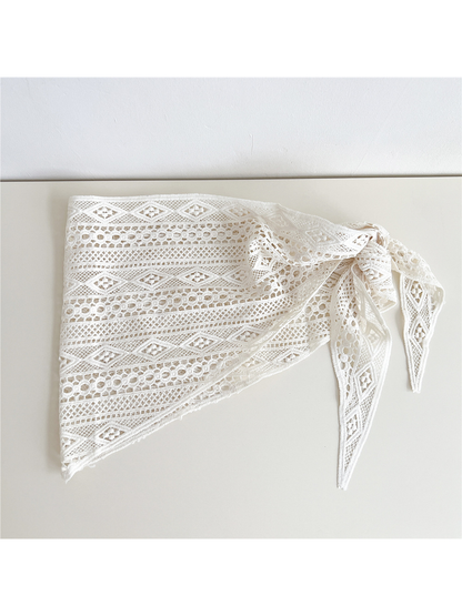 Ivory openwork triangle scarf folded to show its geometric lace pattern