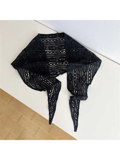 Black openwork triangle scarf laid open with pointed tie ends
