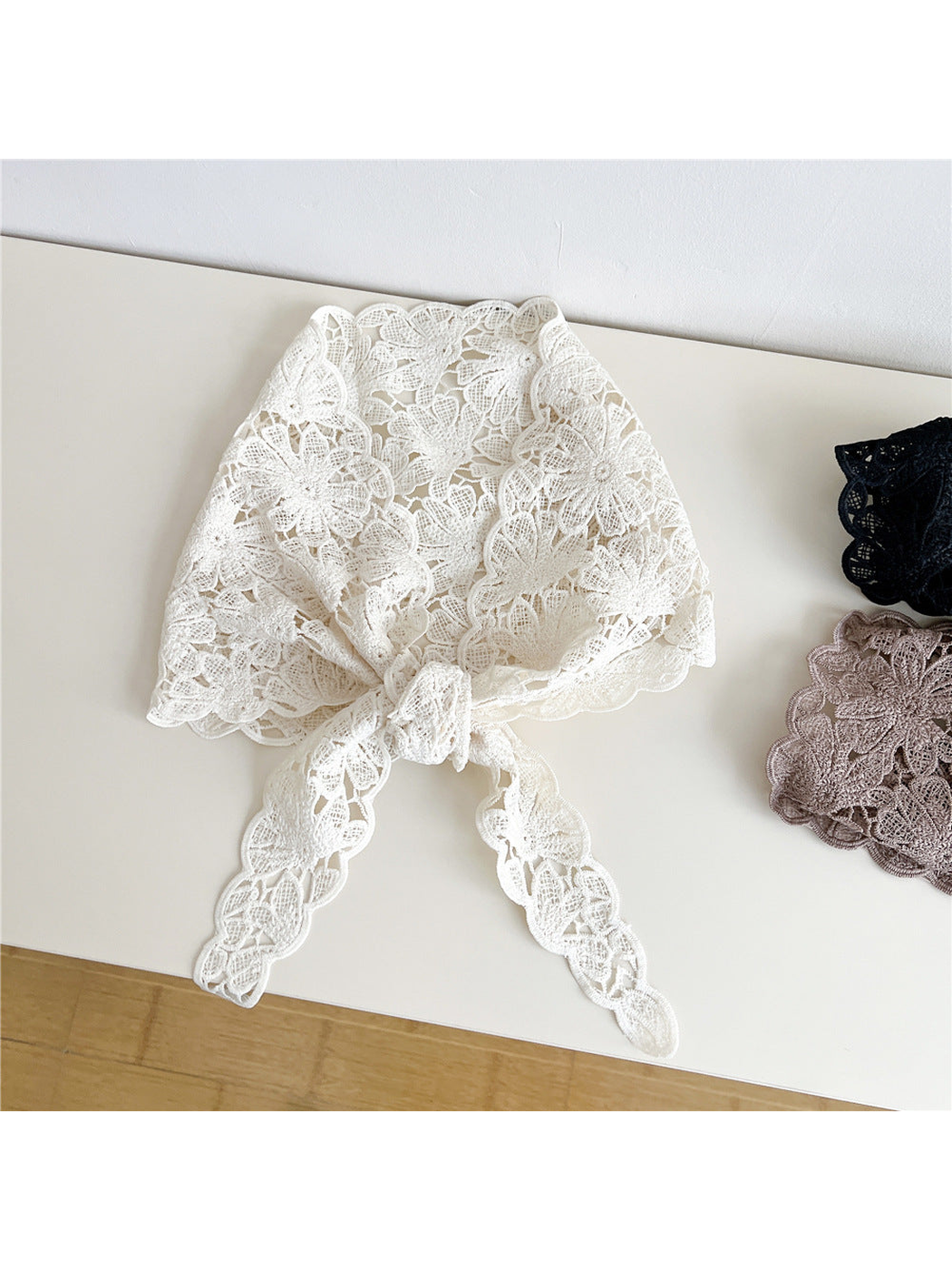 Ivory floral openwork triangle scarf tied at the front