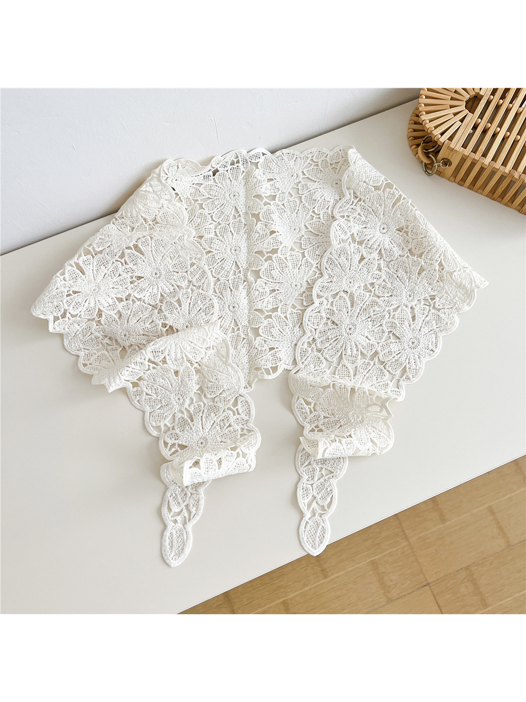 Ivory floral openwork triangle scarf laid open with scalloped edges and tapered ties