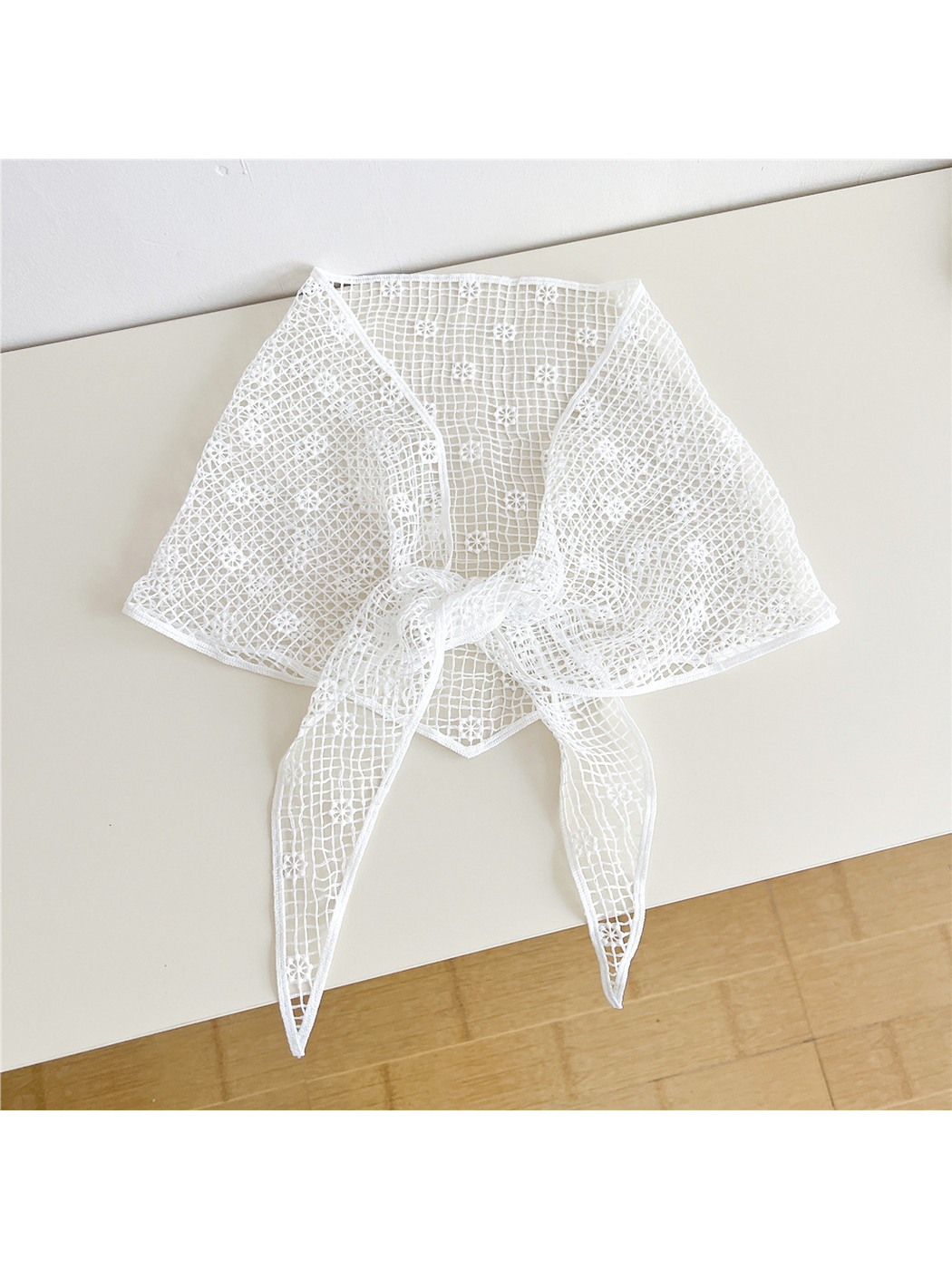 White openwork triangle scarf tied at the front