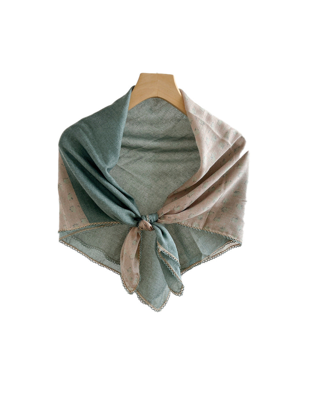 Two-tone green and blush floral scarf tied on a hanger against a white background