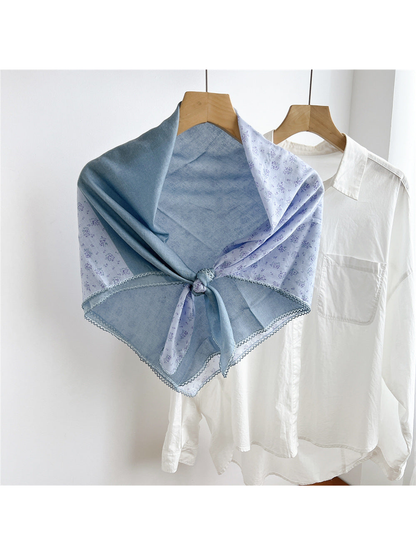 Light Blue two-tone floral scarf tied on a hanger