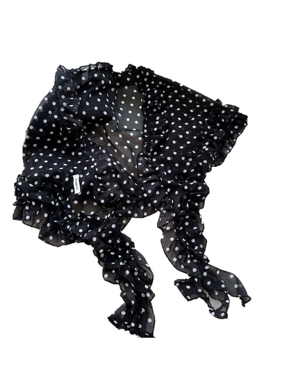 Black sheer polka dot scarf with gathered ruffled trim on a white background