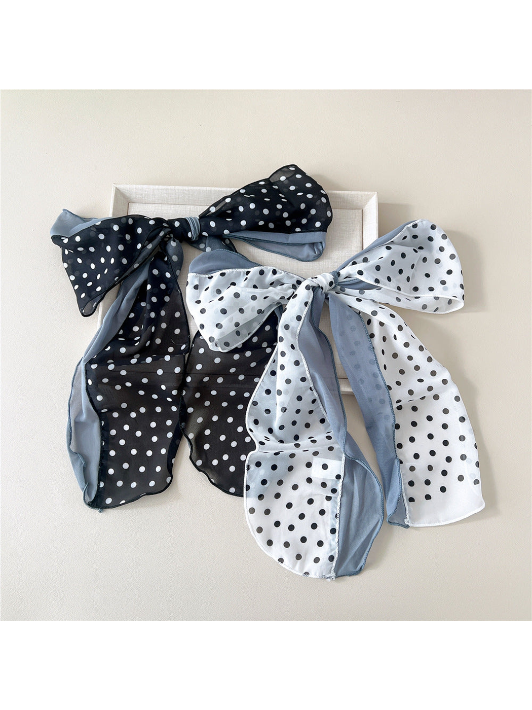 Black and white dot scarves tied in large bows