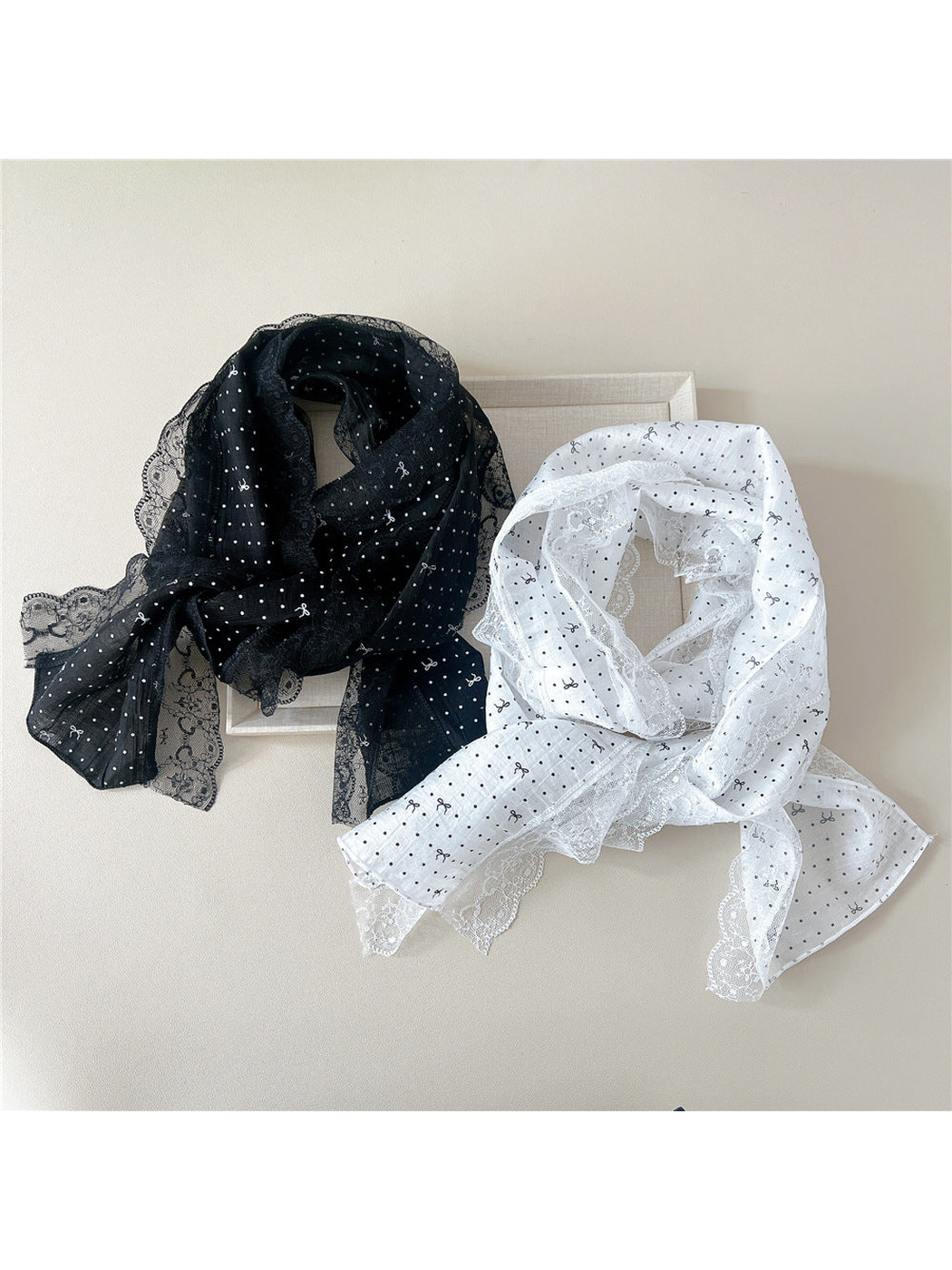 Black and White lace-trim scarves arranged together