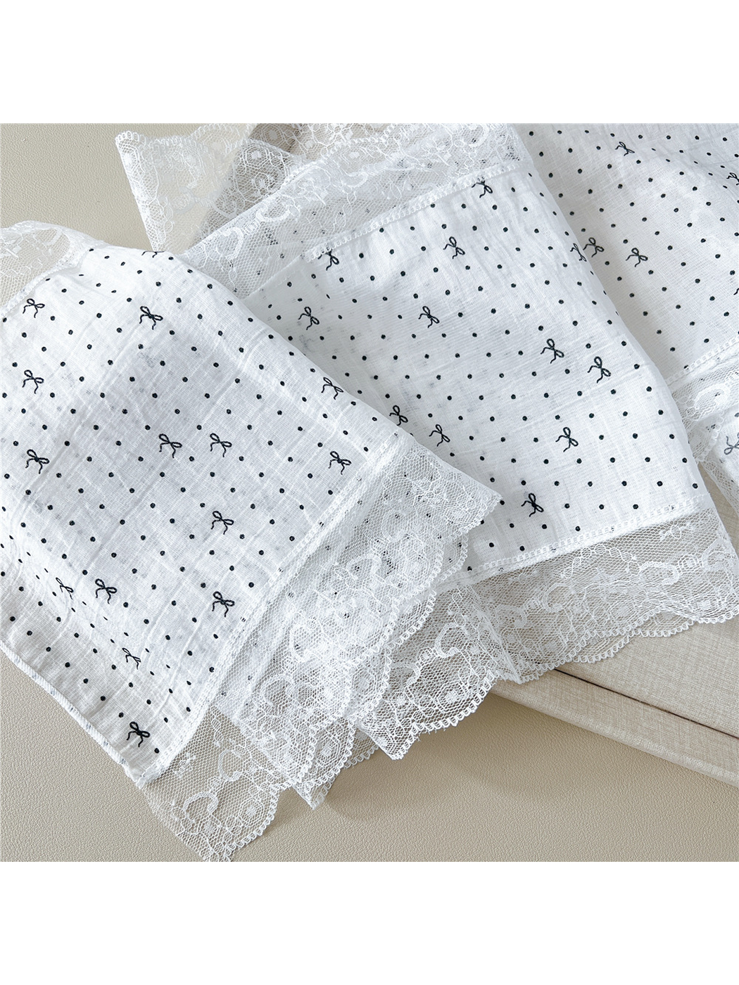 Close-up of dotted bow pattern and scalloped floral lace trim