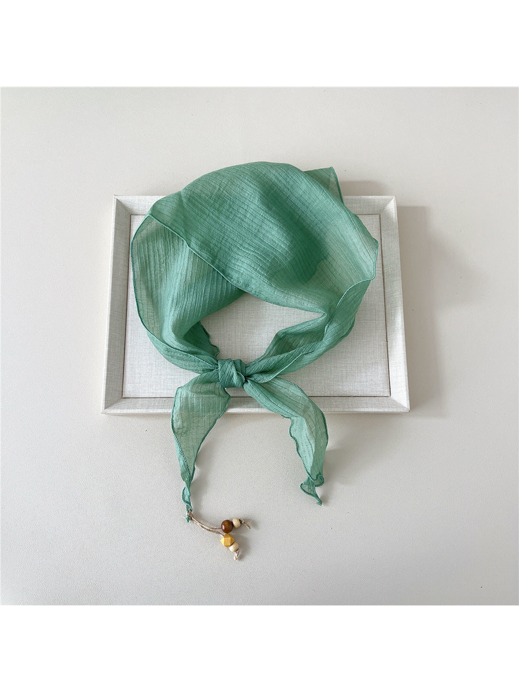 Mint textured scarf tied with bead detail at one pointed end