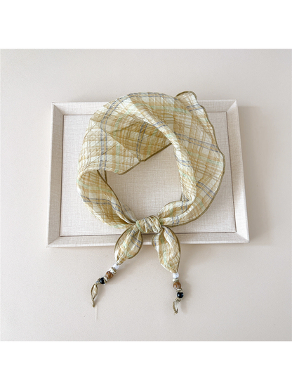 Yellow Plaid triangular scarf tied with beaded tips